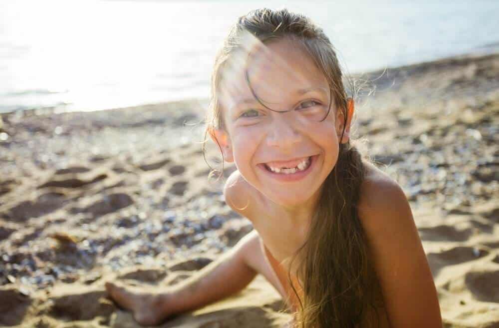 Happy young girl on the beach
