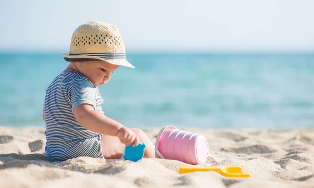 child playing with beach toys
