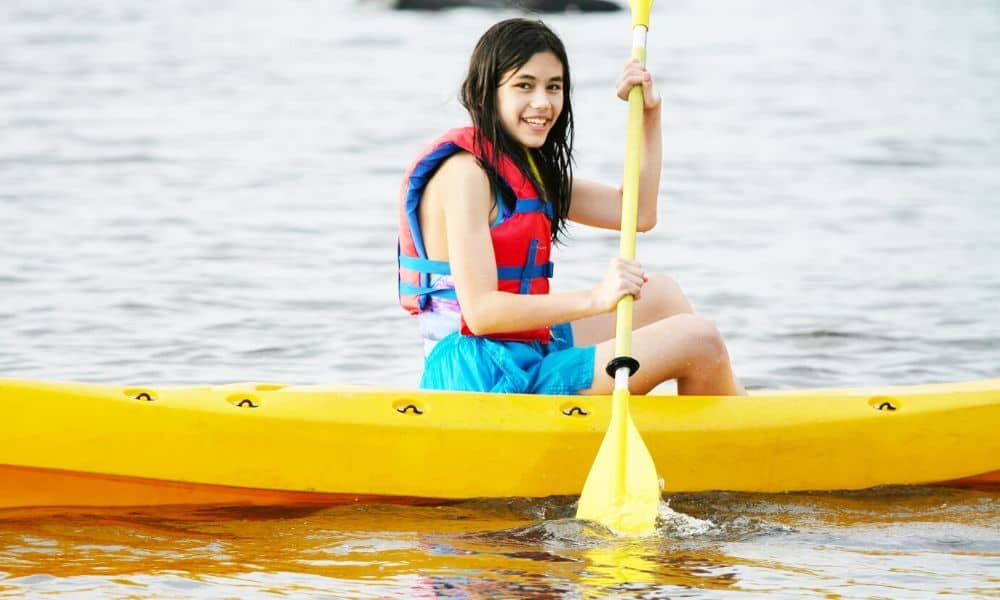 girl kayaking in a lake