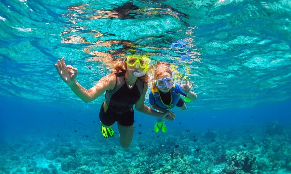 mom and her daughter snorkeling