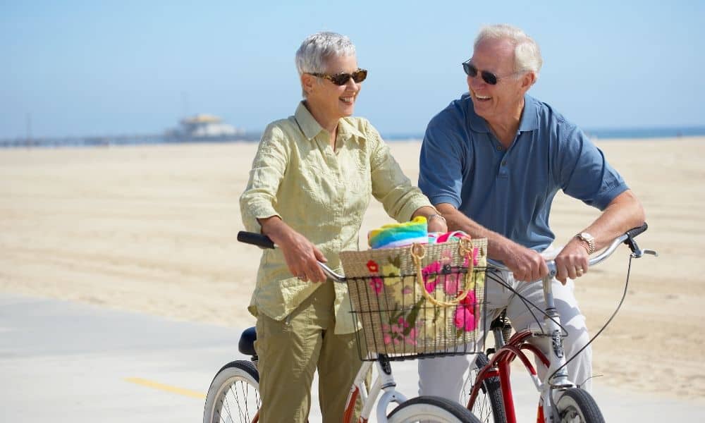 older couple on beach cruisers