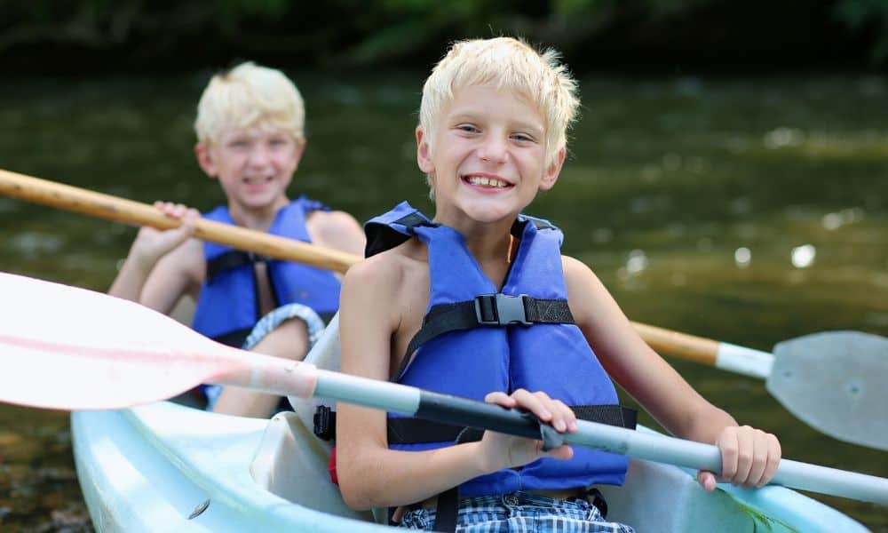 two happy boys kayaking