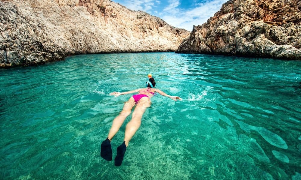 woman snorkeling in tropical water
