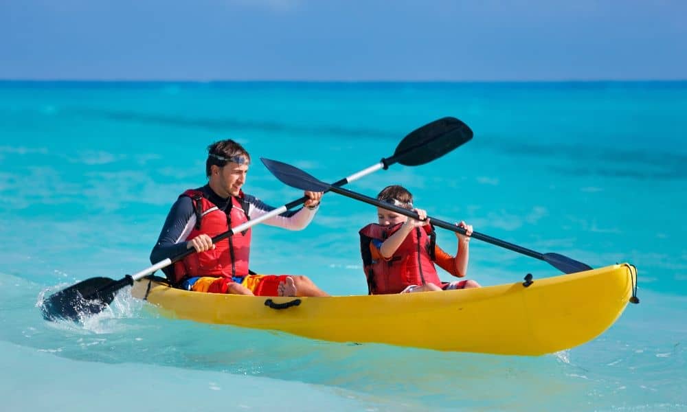 father and son in sit on top kayak